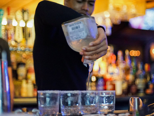 Bartender pouring shots from Patron Bottle
